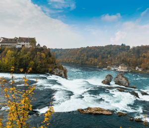 Day 1:  UAE – Zurich. Rhine Falls, Lindt Home of Chocolate and City Orientation Tour